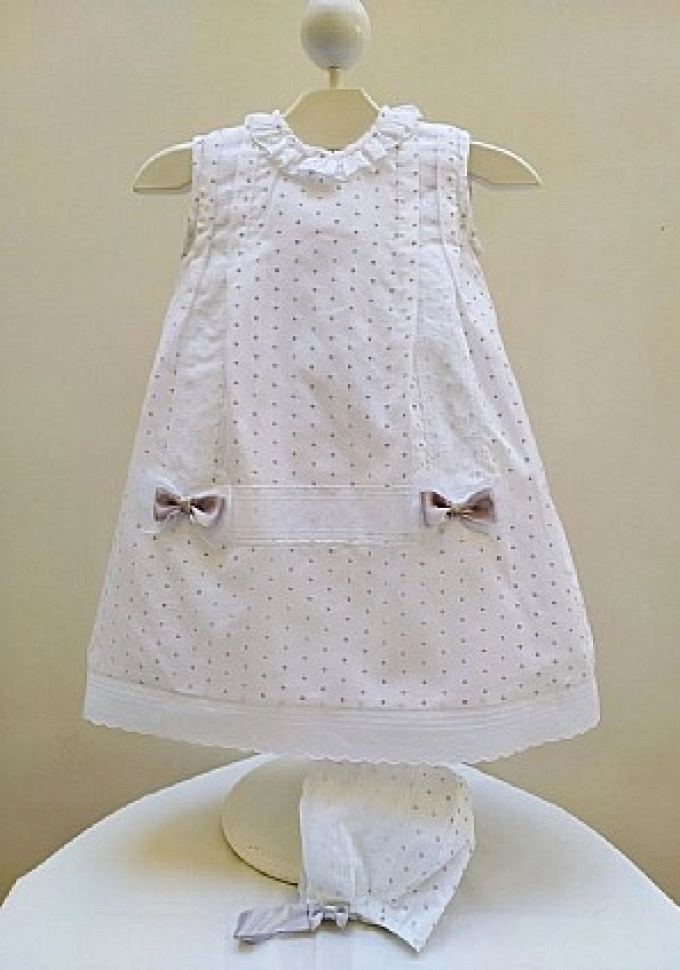 Faldón con capota blanco con bodoques en gris.