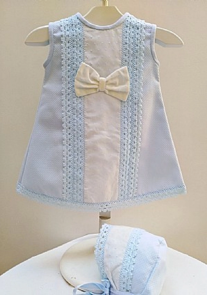 Faldón con capota en celeste con puntillas.